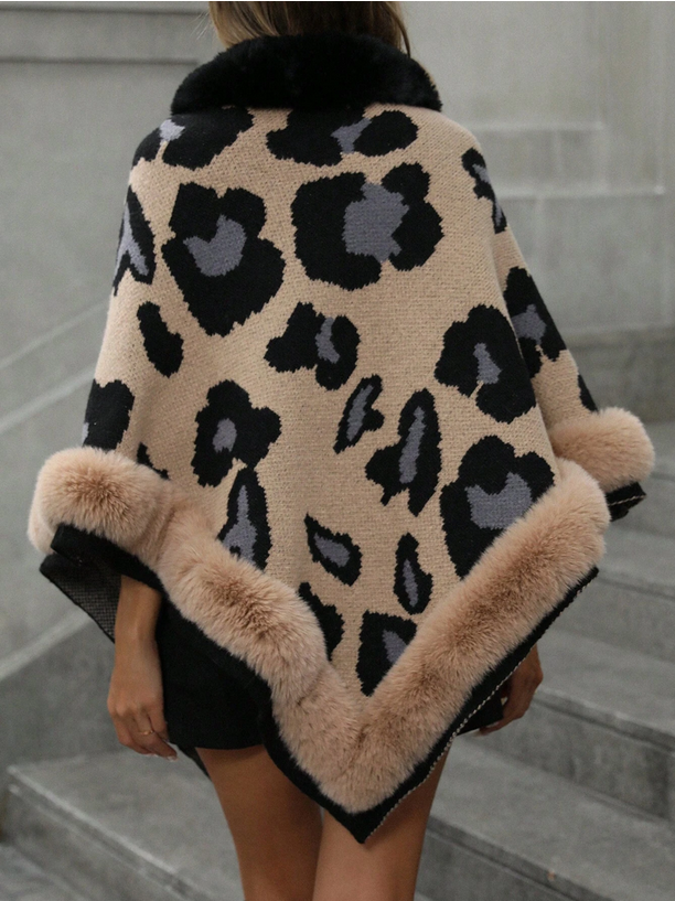 Leopard print coat with fur trim worn by a person on marble steps