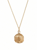 Gold necklace with a detailed pendant on a white background
