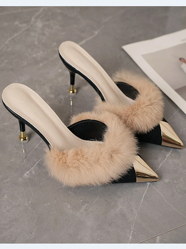 High-heeled shoes with fluffy beige accents on a gray marble surface