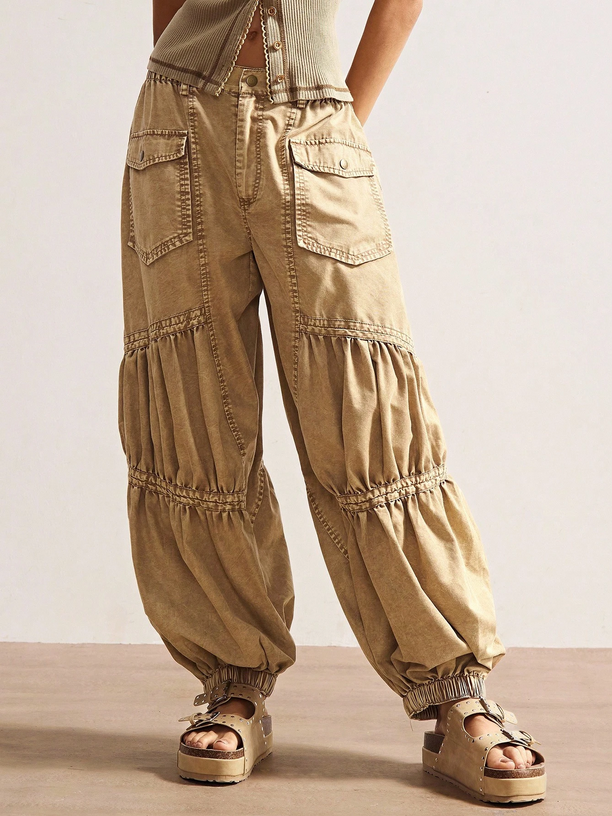 Beige wide-leg pants worn by a person on a neutral background