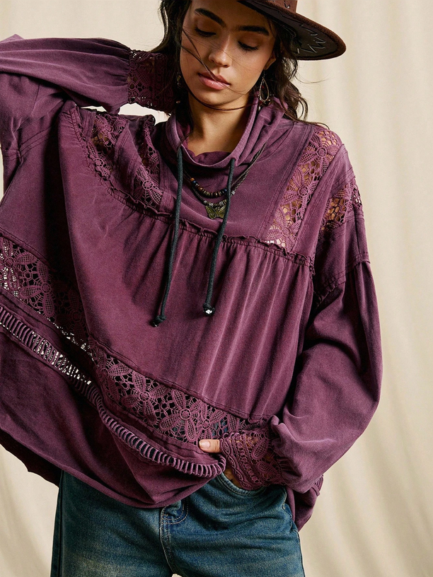 Person wearing a purple lace-trimmed hoodie against a neutral background