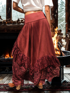 Person wearing a red skirt with ruffles in front of a fireplace