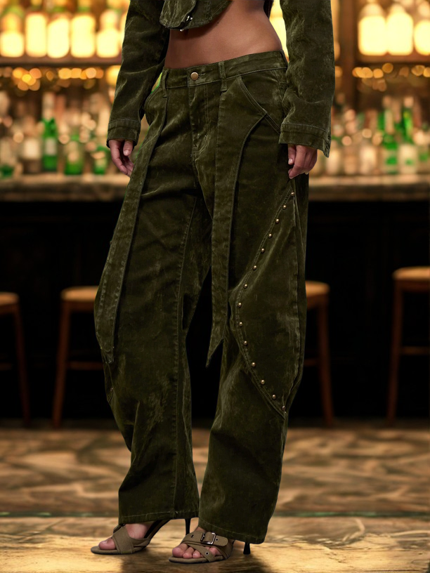Person wearing a long green coat and baggy pants in a bar setting
