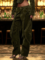 Person wearing a long green coat and baggy pants in a bar setting